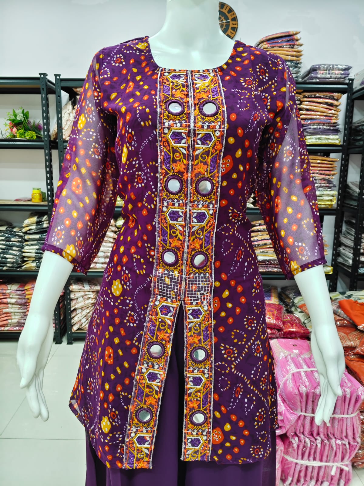 A Rich Purple And Pink Bandhani Printed Plazo set Featuring An Embroidered Front Panel, Flowy Matching Bottoms and A Sheer Dupatta For An Elegant Ethnic Look. (NFRD01)